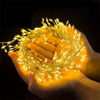 Warm white cluster fairy lights held in cupped hands