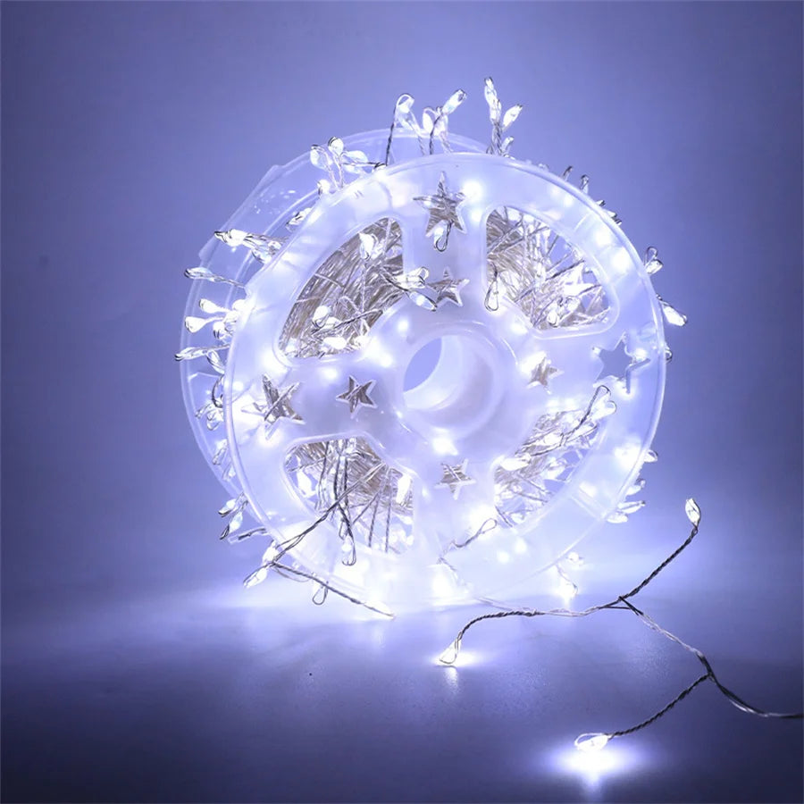 White firecracker cluster lights on a reel with a cool white glow
