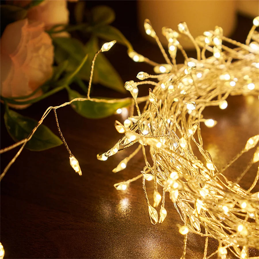 Warm white firecracker cluster lights draped with greenery