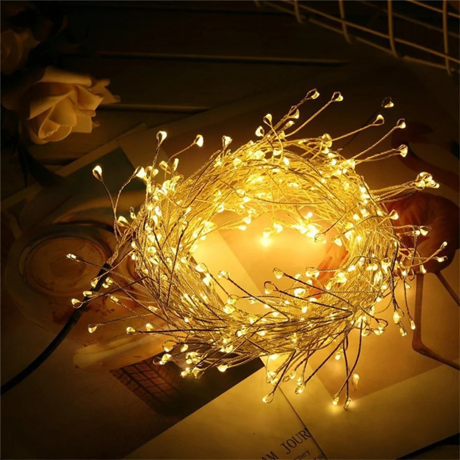 Warm white firecracker cluster lights coiled on a table