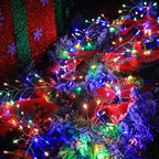 Multicolour firecracker cluster lights on a Christmas tree with red decorations