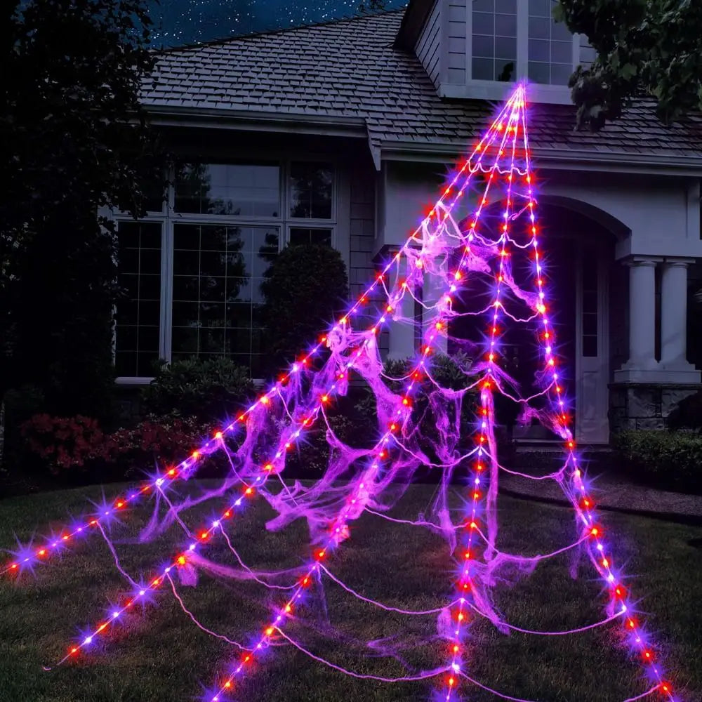 Weaver giant Halloween spider web lights glowing purple outdoors