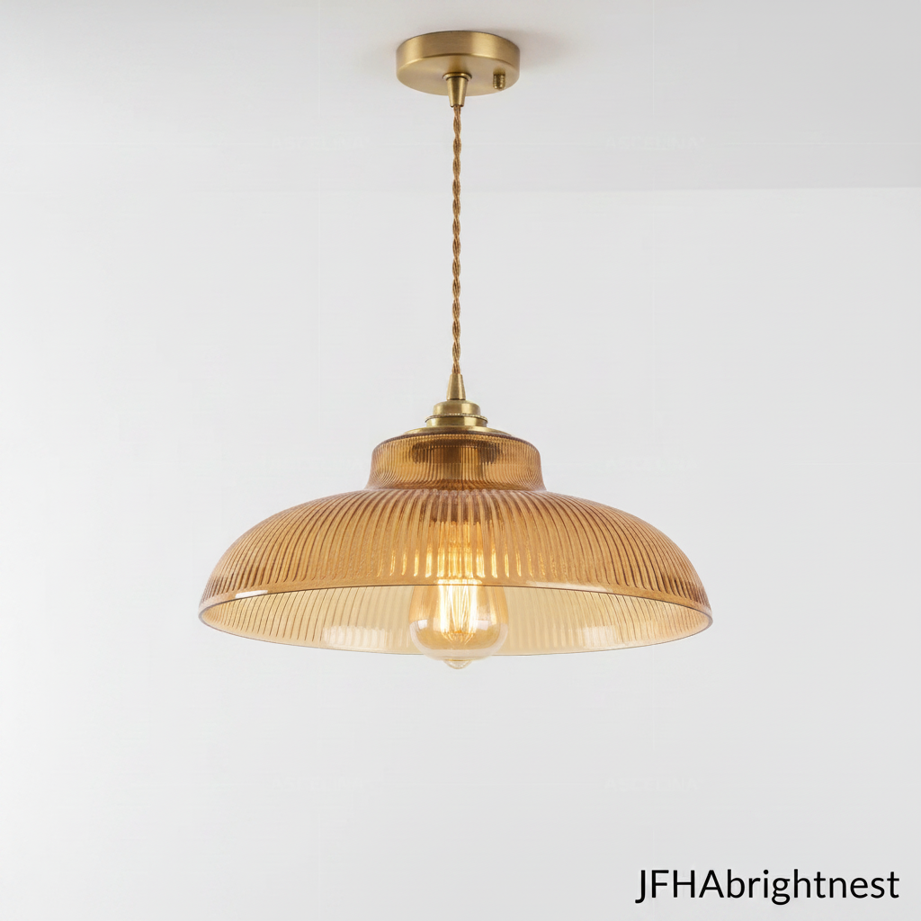 Amber ribbed glass pendant light with brass canopy, twisted gold cable and warm filament bulb