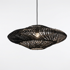 Black woven UFO pendant light on a clean white studio background
