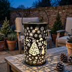 Solar Christmas lantern on a British garden patio table at night