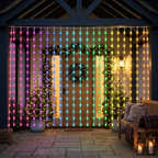 Festive covered porch decorated with rainbow LED curtain lights
