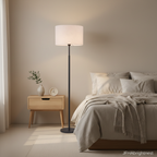 Elin floor lamp with a white fabric drum shade lighting a calm contemporary bedroom