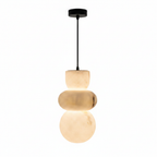 Stacked marble pendant light lit warm, hanging from a black cable and ceiling canopy