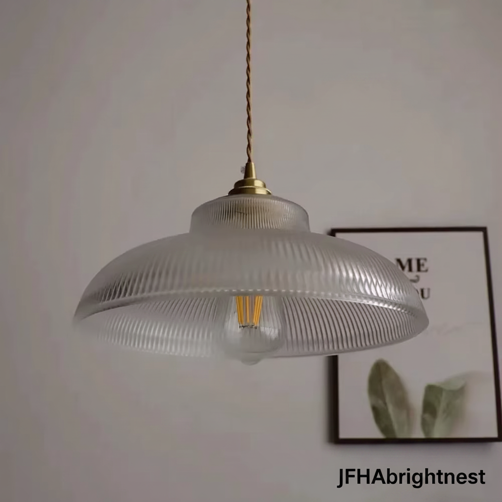 Close-up of the clear ribbed glass pendant shade with a warm filament bulb
