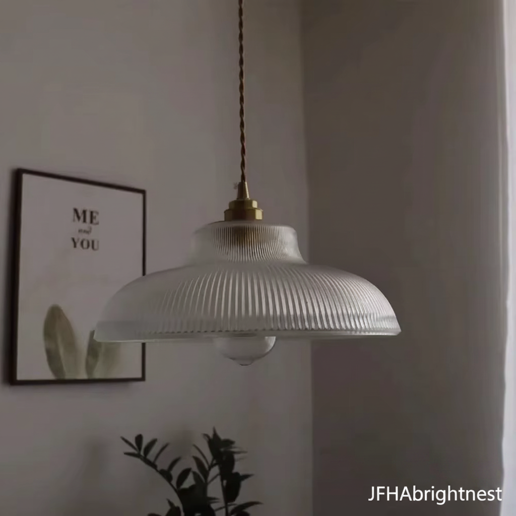 Clear ribbed glass pendant light with brass canopy and twisted gold cable