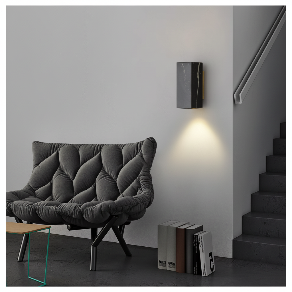 Square black marble wall light casting a warm downward glow on a hallway wall beside a staircase
