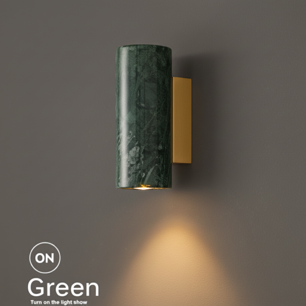 Marble bedside wall light, round green marble shade on a brass bracket, lit with a warm downward glow