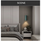Round green marble wall light mounted beside a bed, lighting the bedside table below
