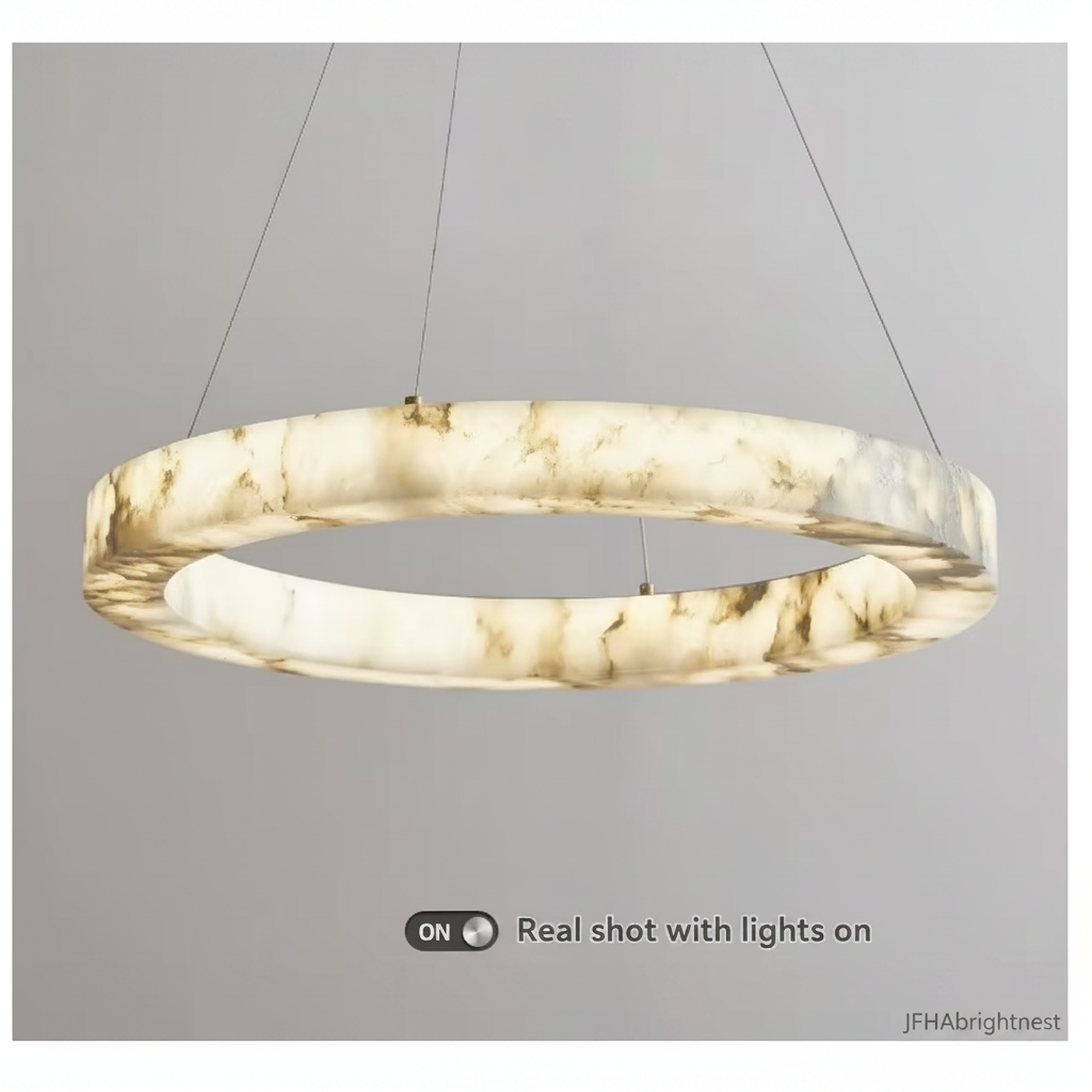 Marble disc pendant light switched on, showing the warm glow through the shade