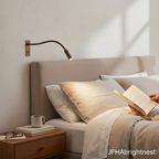 Bronze Halden reading wall light mounted beside a bed