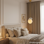 Gold kids globe pendant light hanging beside child's bed in luxury nursery