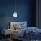 Blue kids globe pendant light hanging beside child's bed in adventure room