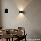 Black Norvik indoor wall light in a dining room