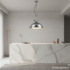 Polished chrome Edison Noir pendant light hanging above a white marble kitchen island