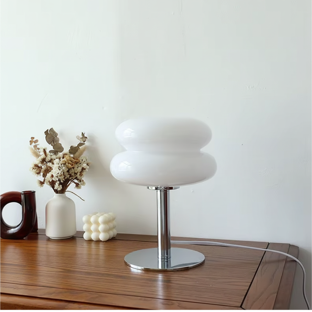 White macaron glass table lamp on a wooden cabinet
