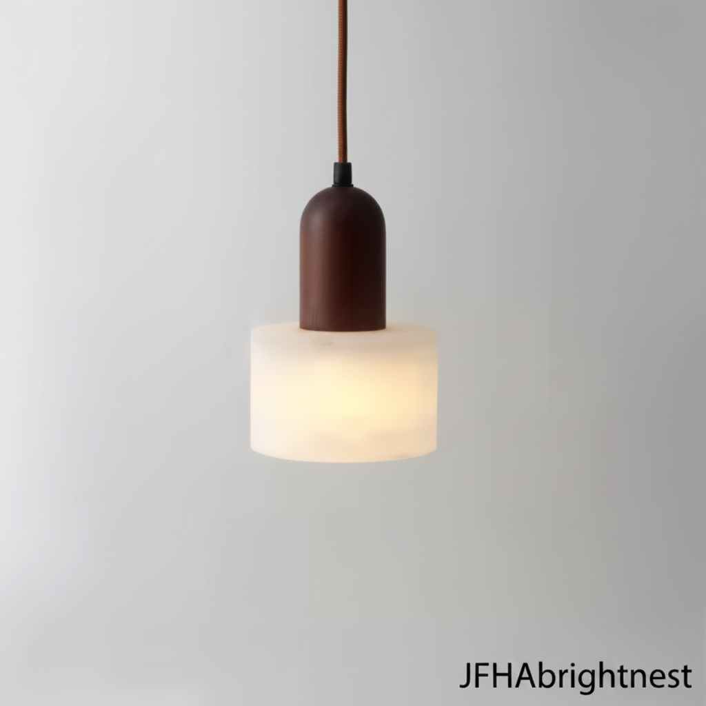 Marble pendant light with a brown wood cap, lit and hanging against a grey wall