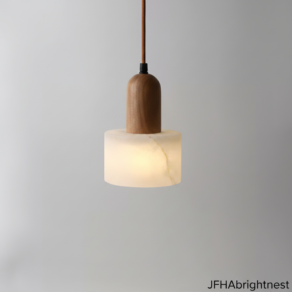 Marble pendant light with a light yellow wood cap, lit and hanging against a grey wall