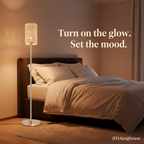Seren crystal floor lamp glowing warm white beside a bed