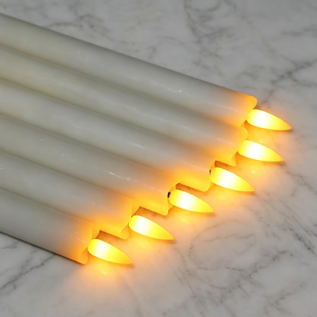 Square clone of six glowing ivory candles on marble