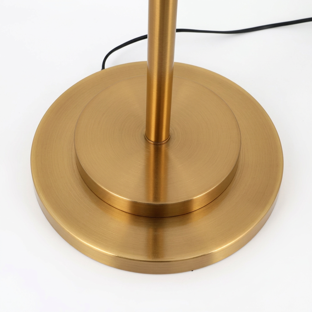 Close-up of the gold metal floor lamp base