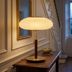 Copper and white glass table lamp on a hallway console