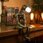 Square product image of the seated robot lamp with a white bulb on a wooden counter