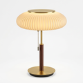 Nordic white glass table lamp switched on with warm 3000K light