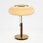 Nordic white glass table lamp switched on with warm 3000K light