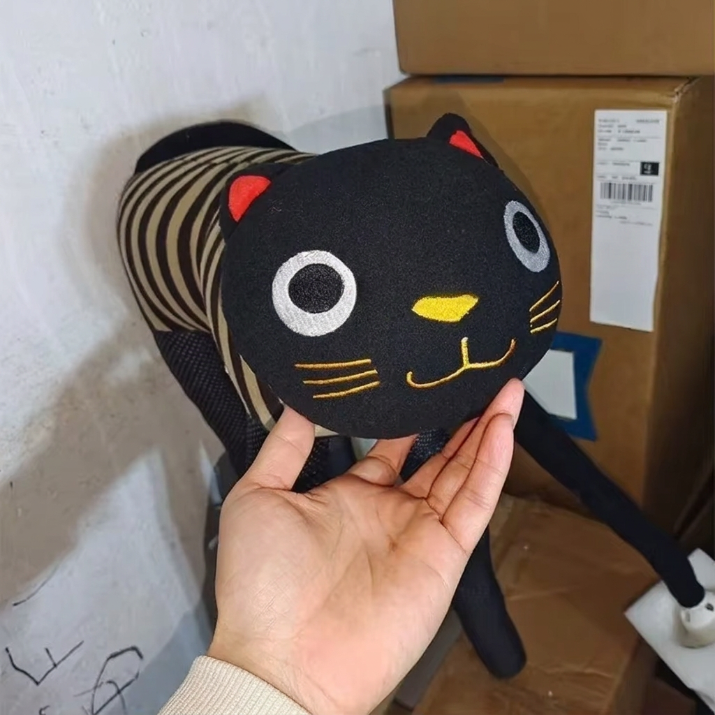 Close-up of the soft fabric cat face on the cat lamp