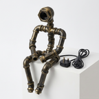 Square studio product image of the seated iron pipe robot lamp without a bulb